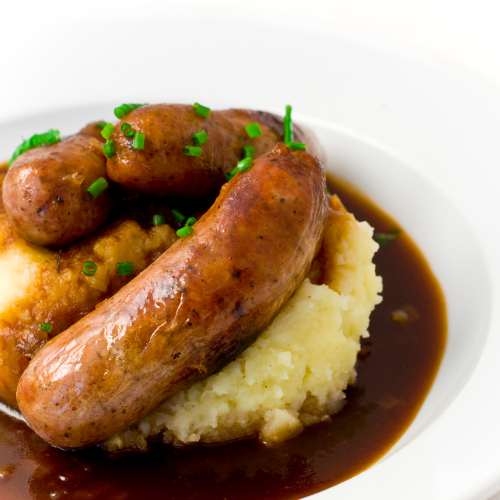 Bangers & Mash sausages, mashed potatoes, onion, peas & gravy